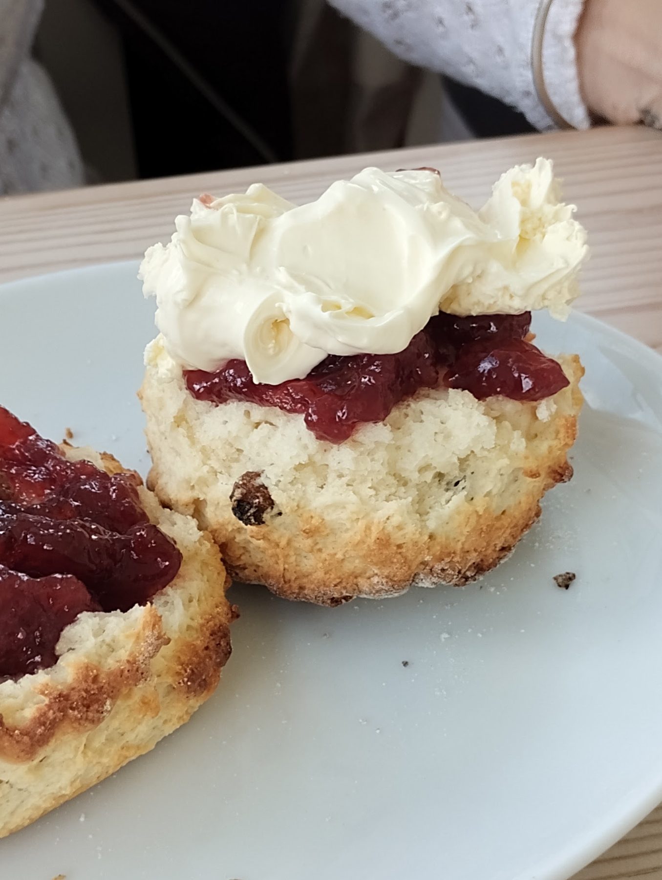 A scone with cream and jam